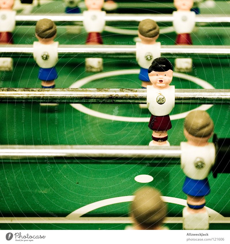 11 accomplices Playing Table Rod Green Break Friendship Joy Sports Ball sports Soccer player Table soccer Shallow depth of field Colour photo Screwed on tight
