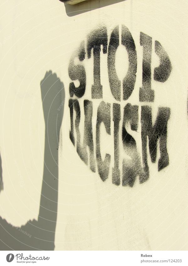 stop racism Stop Fist Wall (building) Human being Hand Spray Racism Quit Strong Plaster Cold Ochre Black Grunge Dirty Shadow play Peace sprayed Graffiti Hatred