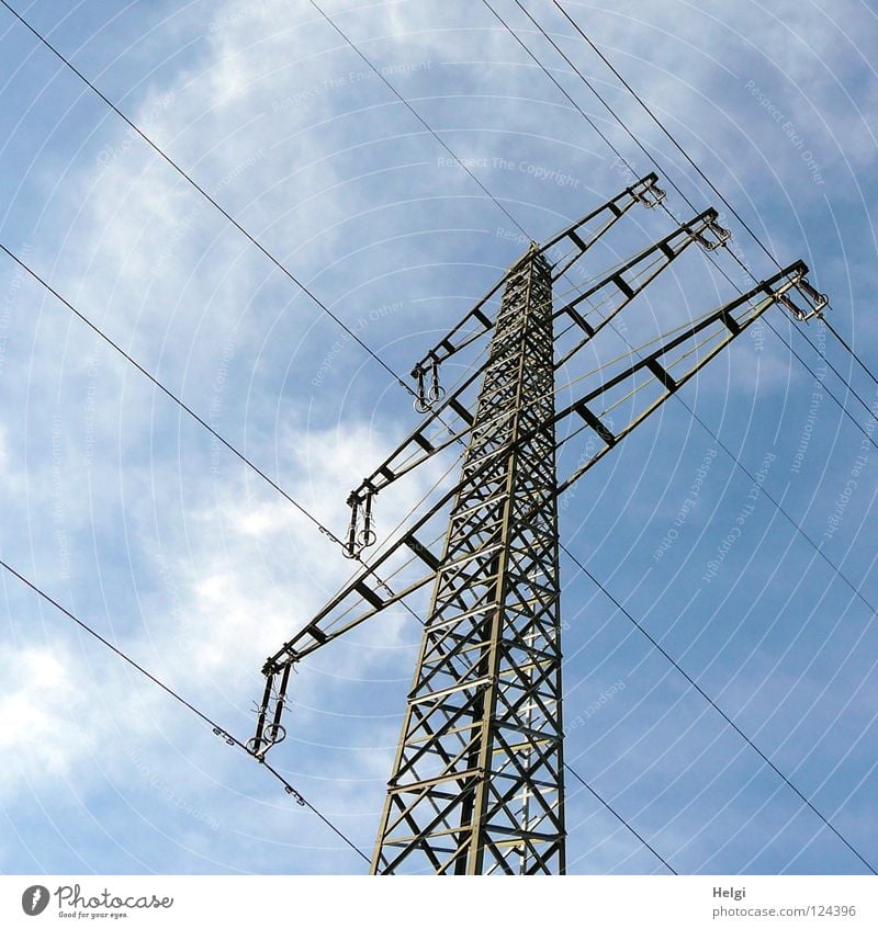 gigantic power pole with power cables in front of blue sky with clouds Electricity pylon Wire Clouds White Gray Large Might Geometry Steel Towering Dangerous