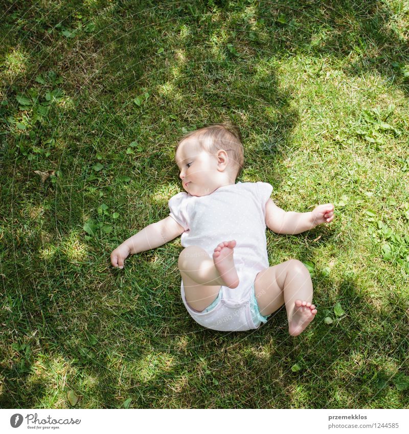 Baby lying on grass Summer Girl Infancy 1 Human being 0 - 12 months Plant Grass Garden Park Small Cute Green Child Nature Natural Exterior shot Day