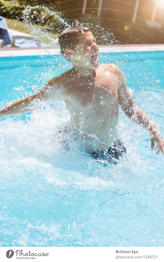 Boy emerges from the water Lifestyle Joy Spa Leisure and hobbies Summer Sun Swimming & Bathing Swimming pool Human being Boy (child) 1 Nature Garden Waves Jump