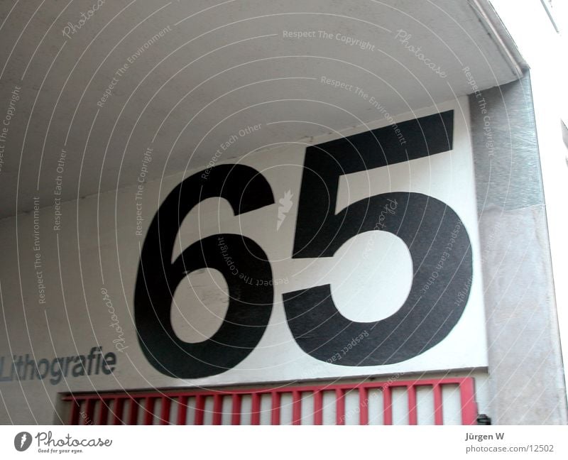 65 Digits and numbers House number Typography Wall (building) Photographic technology Characters writing Wall (barrier)