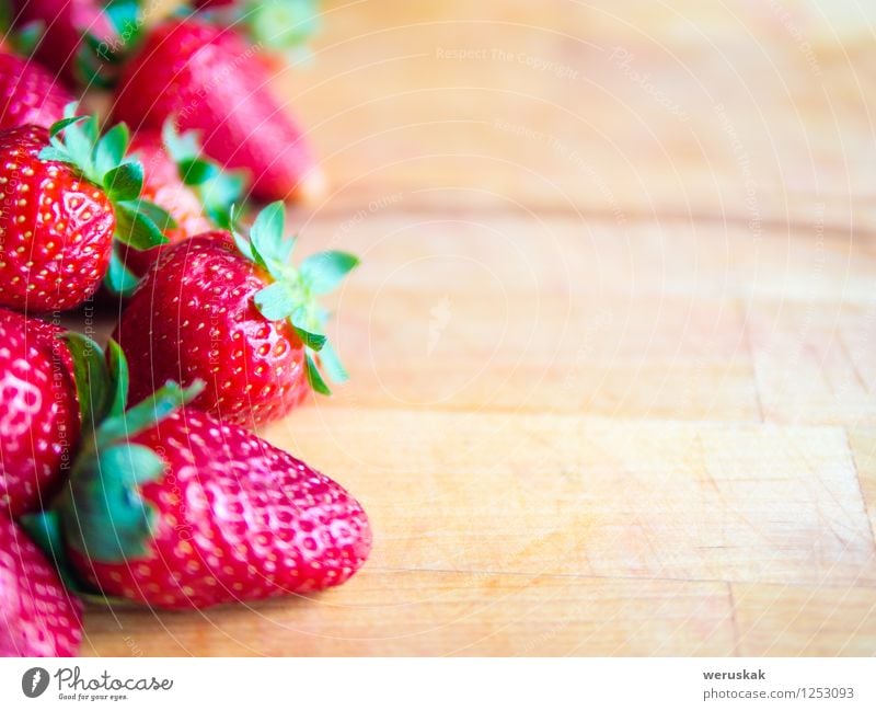 Strawberries on a wooden board with empty space Fruit Nutrition Summer Decoration Fresh Healthy Delicious Natural Juicy Sweet Brown Green Red Berries blured