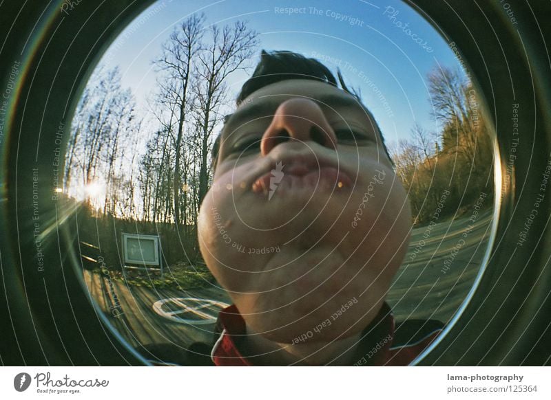 [150] MAKE THICK BAKES Cheek Blow Action Absurdity Playing Boredom Fisheye Round Snapshot Wide angle Man Youth (Young adults) Parking lot Tree Crazy
