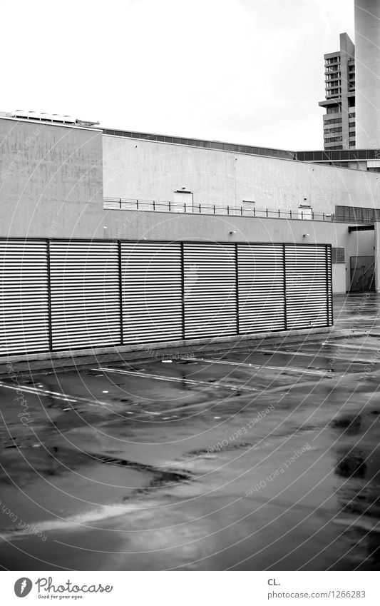 Somewhere Bad weather Rain Town High-rise Places Parking garage Building Wall (barrier) Wall (building) Transport Parking lot Gloomy Black & white photo