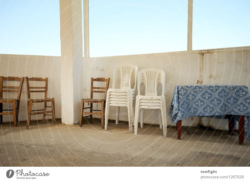 row of chairs with table Chair Table Wooden chair Plastic chair Stone Old Blue Calm Stagnating Tablecloth Window pane Colour photo Interior shot Morning Light