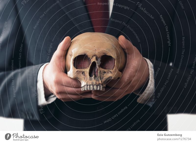 businessman with a skull in his hands Life Financial Industry Stock market Financial institution Business Company Human being Masculine Man Adults Head Hand