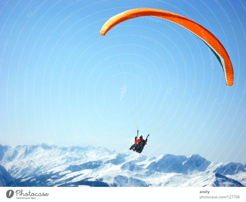 flight Paragliding Parachute Winter Panorama (View) Peak Glide Vantage point Austria Air Fantastic Paraglider Joy Extreme sports Mountain Freedom Blue sky Snow