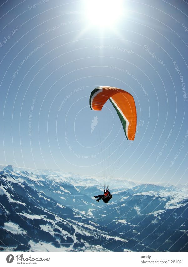 HeightsSunFlight Paraglider Paragliding Federal State of Tyrol Winter Hover Sunbeam Austria Sports Playing Mountain Alps Flying Blue Snow Freedom Vantage point