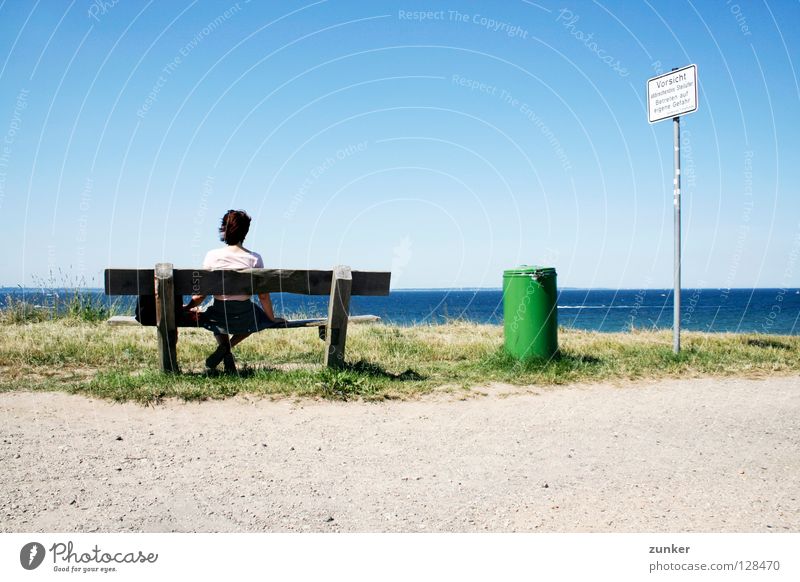 Watch it! Watch it! Woman Wood Trash container Green Ocean Far-off places Grass Loneliness Break Exterior shot Beach Coast Summer Back Bench Water Sky