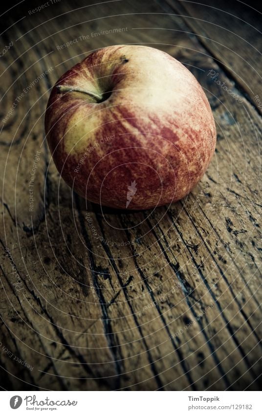 The apple in and of itself Table Tabletop Wood Wooden table Healthy Dark Kitchen Stalk Still Life Yellow Red Vitamin Meal Diet Snack Snack bar Apple skin Fruit