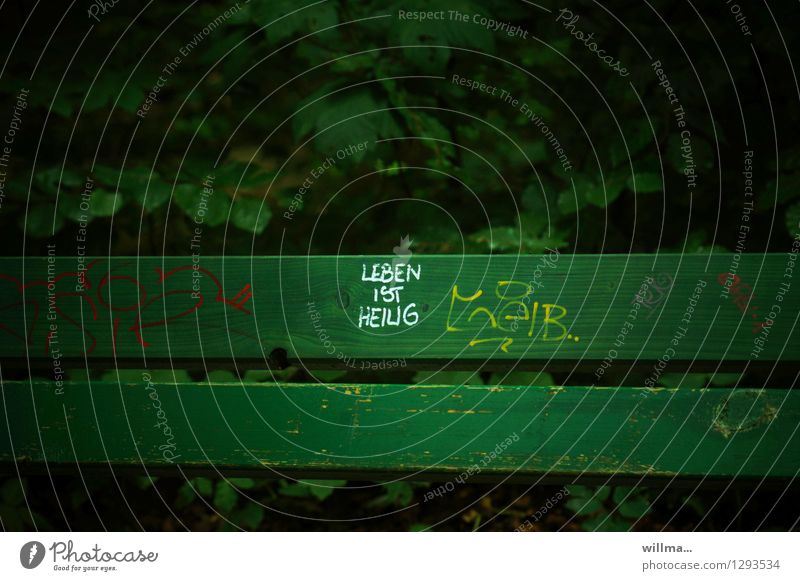 Life is sacred. Holy Text Figure of speech Characters Bench Dark green Park bench Meaning Green Daub Graffiti Religion and faith