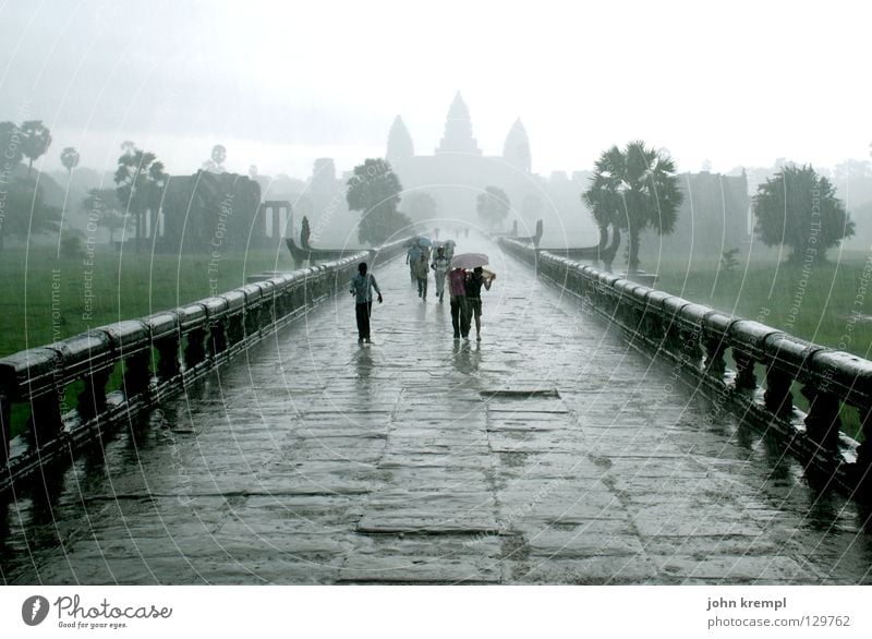 through the monsoon Angkor Wat Cambodia Temple Holy Ruin Virgin forest Khmer people Clouds Bad weather Monsoon Unload Rain Flee Wet Landmark Monument Asia