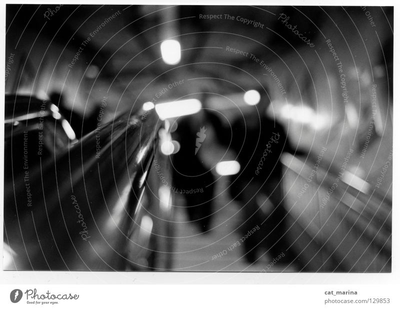 London - Tube Underground Escalator Depth of field Impersonal Dark Black & white photo Man lonely Town