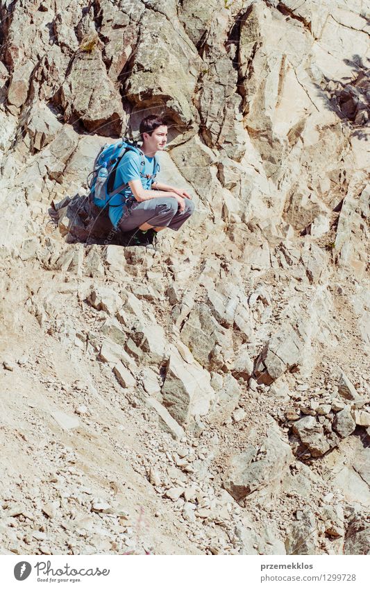 Boy sitting on the rocky hillside Vacation & Travel Trip Adventure Summer Mountain Hiking Boy (child) Young man Youth (Young adults) 1 Human being 13 - 18 years