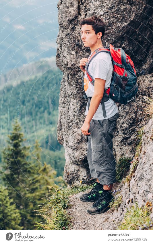 Boy standing on the rocks in the mountains Vacation & Travel Trip Adventure Summer Summer vacation Mountain Hiking Child Boy (child) Young man