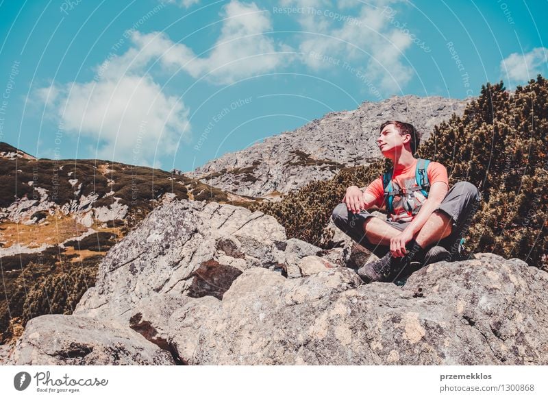 Boy resting on a rock in the mountains Lifestyle Vacation & Travel Trip Adventure Freedom Summer Mountain Hiking Boy (child) 1 Human being 13 - 18 years
