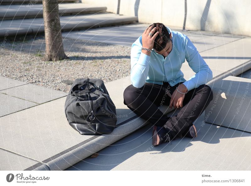 Man with travel bag, sitting on a landing holding his head with lowered gaze Masculine 1 Human being Tree trunk Stairs Shirt Pants Brunette Short-haired Bag
