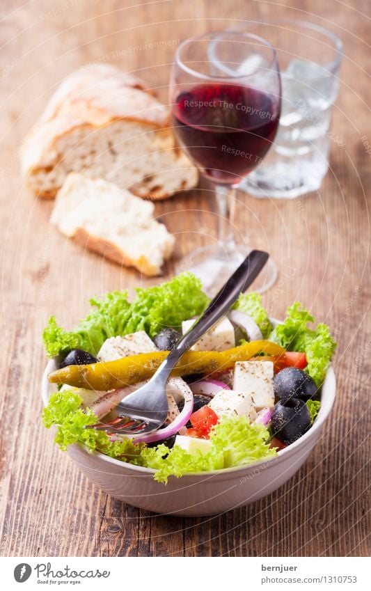 Greek salad Food Lettuce Salad Bread Nutrition Vegetarian diet Beverage Drinking Drinking water Wine Bowl Cutlery Fork Cheap Good Red wine Wine glass Tumbler