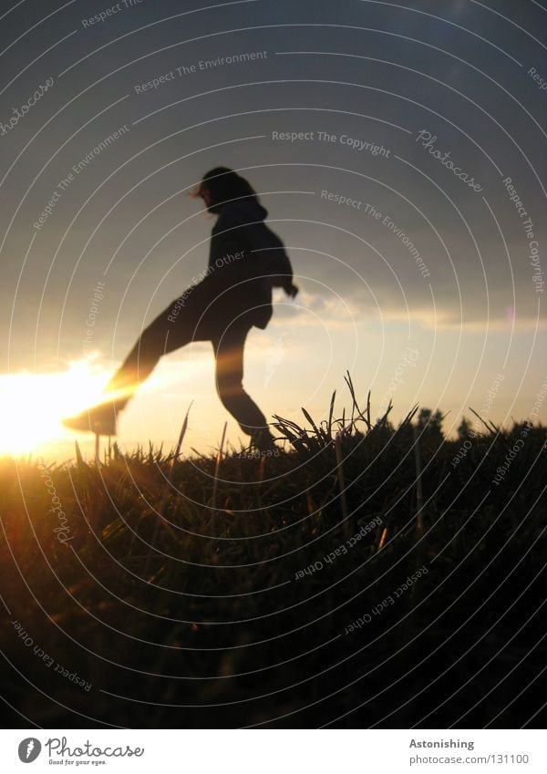 Step against the sun Light Sunbeam Moody Sunset Tread Meadow Clouds Playing Human being Legs Feet Shadow Lighting Lamp Evening skies Contrast