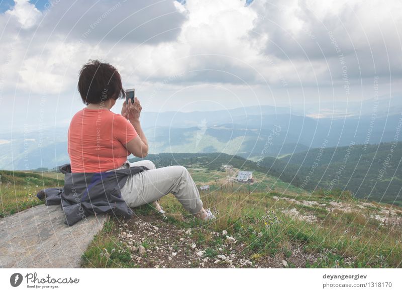 Senior woman taking photos with smartphone Lifestyle Beautiful Relaxation Mountain Retirement PDA Camera Human being Woman Adults Man Couple Nature Landscape
