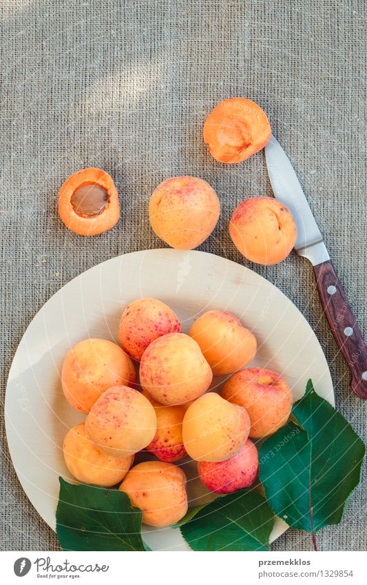 Fresh apricots straight from the garden on wooden plate Food Fruit Organic produce Plate Summer Nature Delicious Sweet Yellow Orange Apricot healthy linen pit