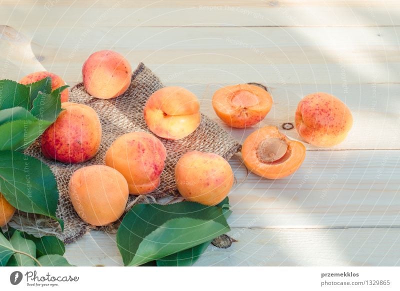 Fresh apricots straight from the garden on wooden table Food Fruit Organic produce Summer Table Nature Leaf Delicious Natural Yellow Green Orange Apricot