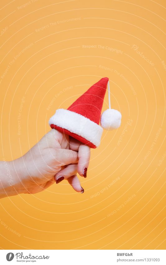 Christmas is coming... Joy Feasts & Celebrations Christmas & Advent Hand Fingers 1 Human being Santa Claus Santa Claus hat Tuft Sign To hold on Carrying