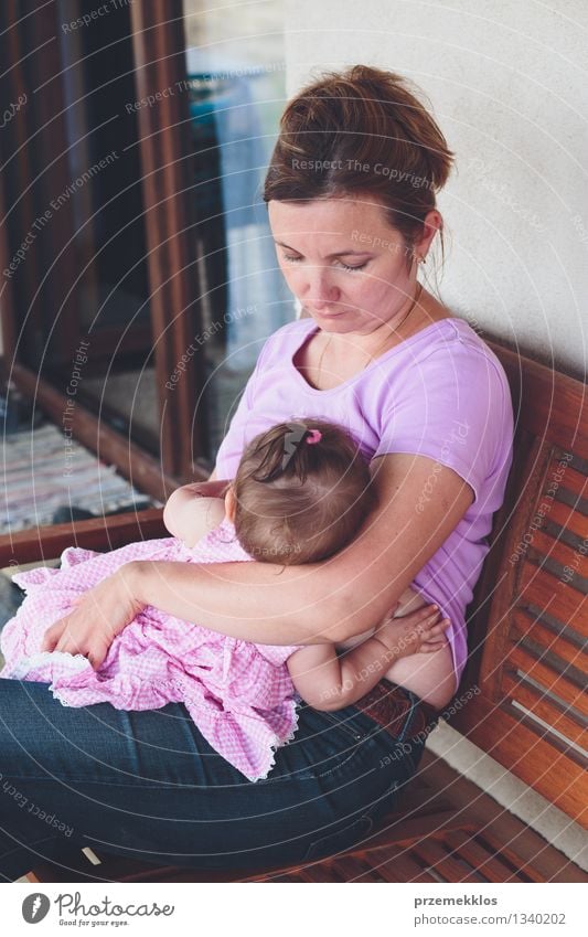 Mother is breast-feeding a newborn baby. Little baby girl breast feeding  Stock Photo