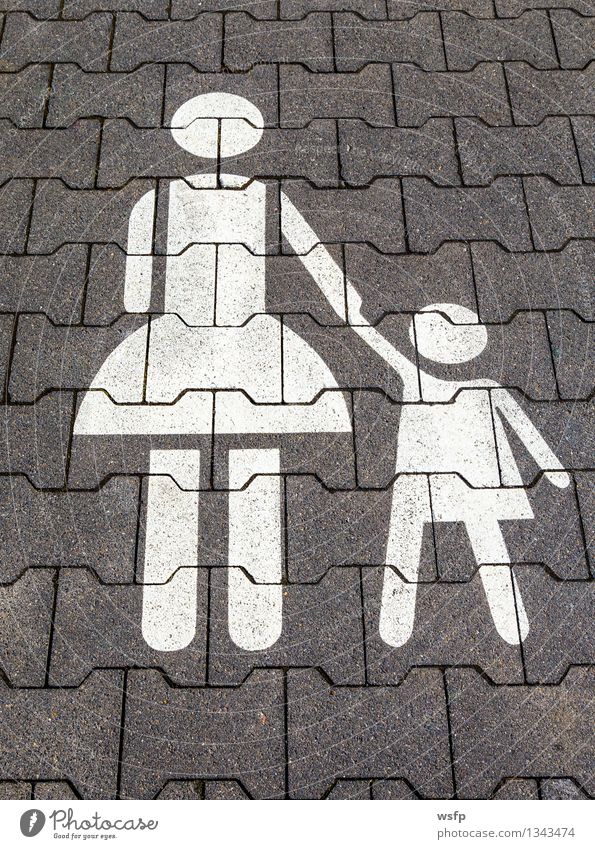 Mother with child symbol on a parking lot Kindergarten Child Parents Adults White Symbols and metaphors Parking lot Asphalt Child-friendly Single parent