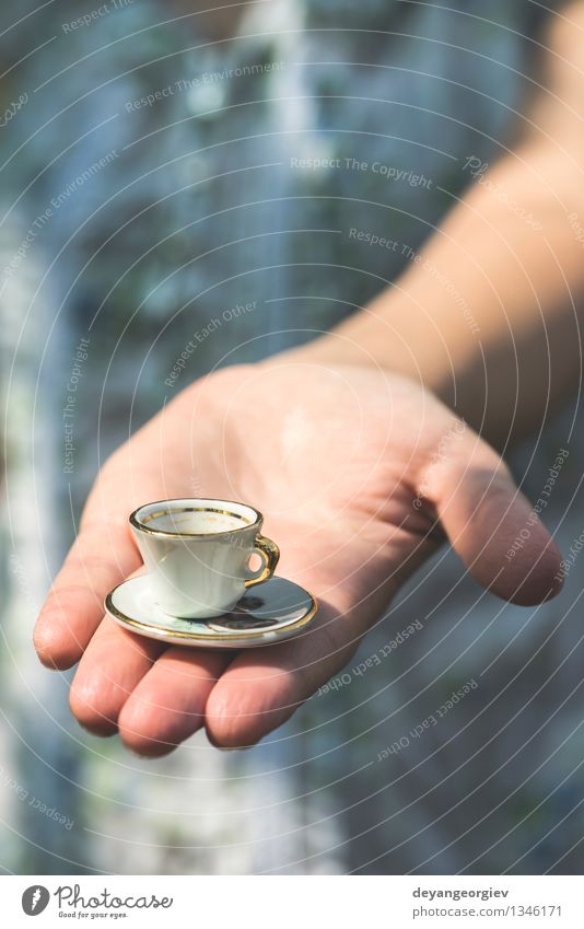 Hand Hold Very Small Cup Of Coffee. Miniature Cup Stock Photo