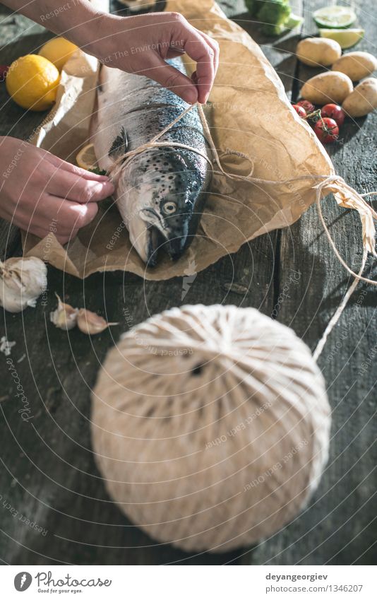 Tying a rope on fish for grilling Seafood Vegetable Dinner Table Rope Paper Dark Fresh Delicious Black Cooking Raw vintage healthy mediterranean Ingredients