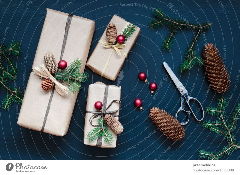 Wrapped Christmas presents on the table Handicraft Scissors Paper Packaging Box String Tradition Guest December Gift Home Horizontal Pine Seasons Colour photo