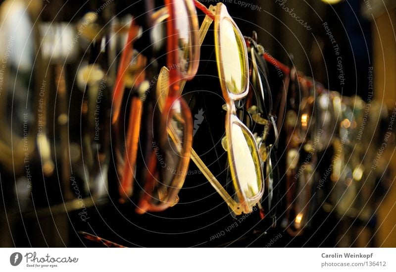 Insight. Eyeglasses Sunglasses Reading glasses Clothesline Blur Depth of field Red Yellow Flea market Junk Art Culture