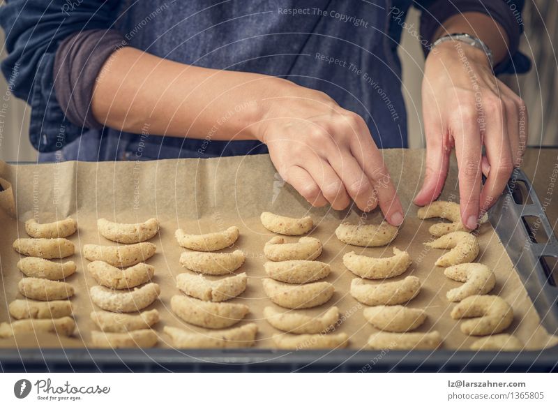 Cook preparing crescent biscuits for Christmas Dessert Nutrition Woman Adults Hand Stove & Oven Fresh Gold arrange arranging Bakery Confectionary Cookie fat