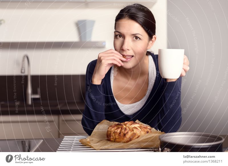 Young woman tasting her freshly baked cake Fruit Apple Dessert Eating Coffee Lifestyle Happy Face Kitchen Cook Woman Adults 1 Human being 30 - 45 years Brunette