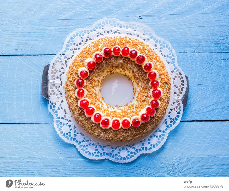 Frankfurt wreath with cherries on blue wood Cake Dessert Wood Blue frankfurt wreath butter cream cake annular Cherry foam pastries Cream Gateau cake top