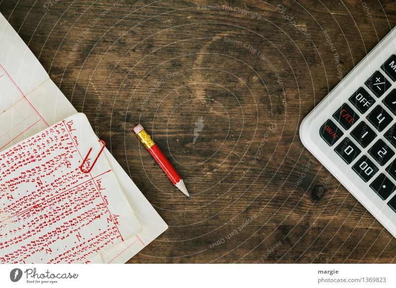 Red numbers with calculator and red pencil on an old wooden table Professional training Study Work and employment Office work Workplace Financial Industry