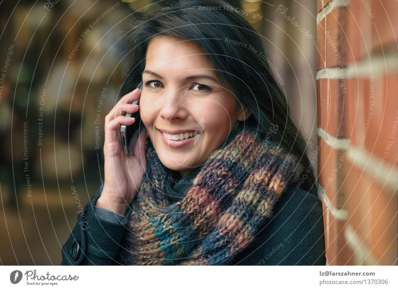 Smiling Woman in Autumn Fashion Talking on Phone Lifestyle Happy Beautiful Face Winter To talk Telephone PDA Adults Town Street Coat Scarf Brunette Happiness