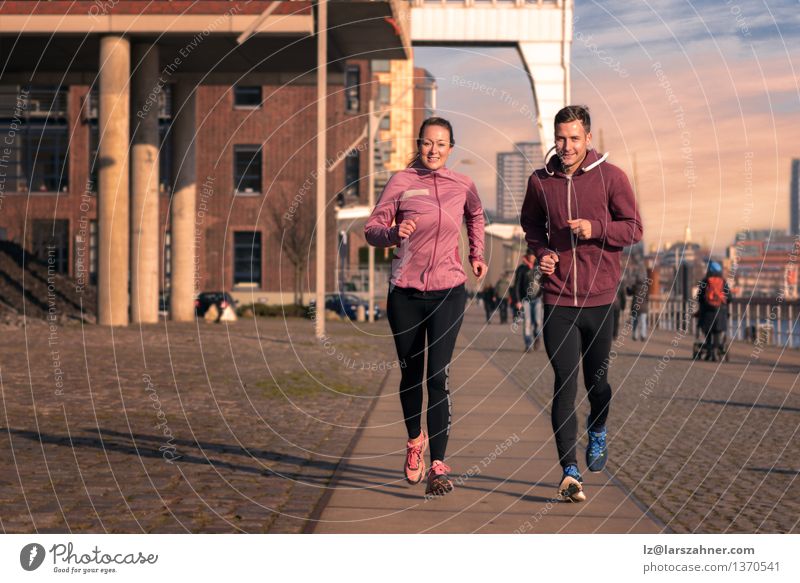 Young couple running on a seafront promenade Lifestyle Face Relaxation Sports Jogging Woman Adults Man Couple Partner 2 Human being 18 - 30 years