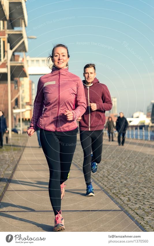 Young couple running on a seafront promenade Lifestyle Face Relaxation Sports Jogging Woman Adults Man Couple Partner 2 Human being 18 - 30 years