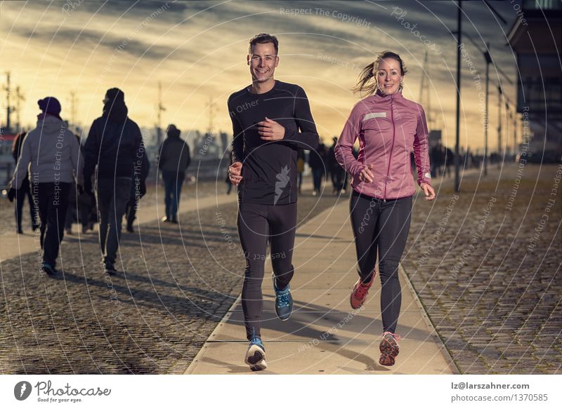 Active young couple jogging on a harbor promenade Lifestyle Face Sports Success Jogging Woman Adults Man Couple 2 Human being 18 - 30 years Youth (Young adults)