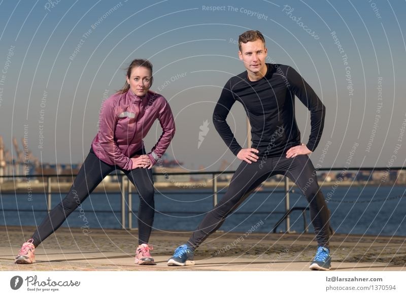 Young couple exercising at the waterfront Lifestyle Body Wellness Leisure and hobbies Sports Jogging Woman Adults Man Friendship Couple 2 Human being Autumn