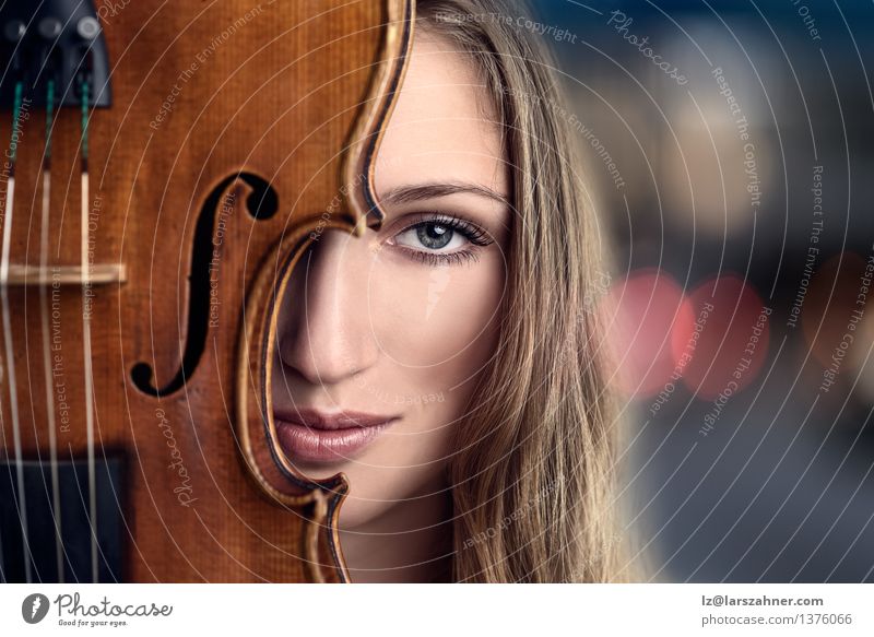 Pretty Young Woman Peeking Behind Violin Face Leisure and hobbies Music Profession Adults Musician Blonde Smiling Friendliness Blue attractive