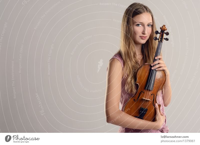 Attractive young musician holding her violin Face Leisure and hobbies Entertainment Music Academic studies Profession Girl Woman Adults Youth (Young adults) 1