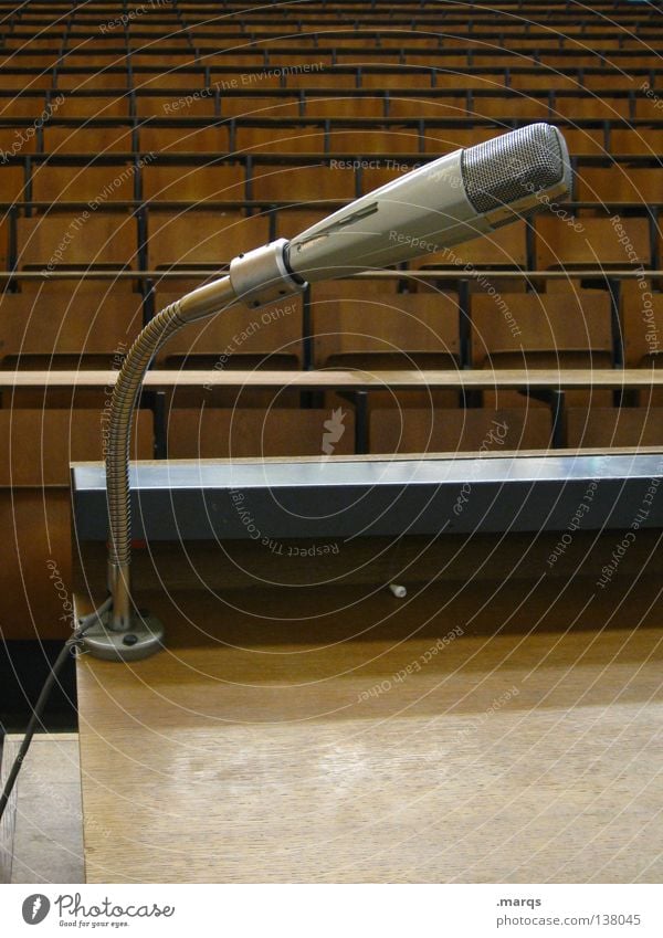speech Speech Lecture hall Audimax Academic studies Microphone Gray Brown Table Chair Row of seats Wooden bench Grid Seating capacity Incline Black Expectation