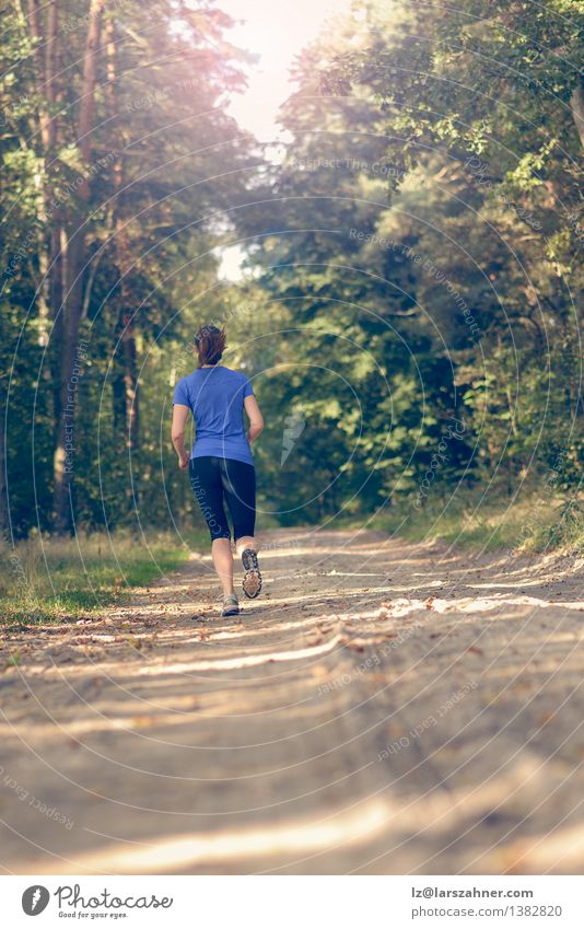 Athletic young woman jogging along a forest track Lifestyle Body Summer Sports Jogging Girl Woman Adults 1 Human being 18 - 30 years Youth (Young adults) Nature