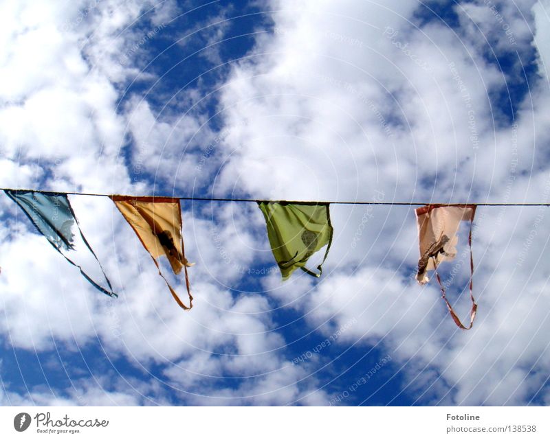 Pennant on a leash in front of a blue sky with many thick clouds Colour photo Multicoloured Exterior shot Deserted Copy Space top Copy Space bottom Day