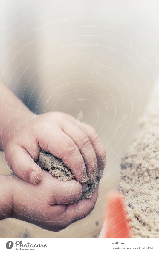 Child hands of a toddler shape sand - 'bake bake cake'. Children`s hand Sand Sandpit Playing Toddler Hand Fingers Cute Sandcastle Sand cake Playground Parenting