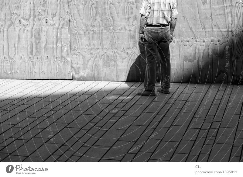 A man stands in front of a wall. Human being Masculine Man Adults Life 1 45 - 60 years Summer Beautiful weather Wall (barrier) Wall (building) Stand Loneliness